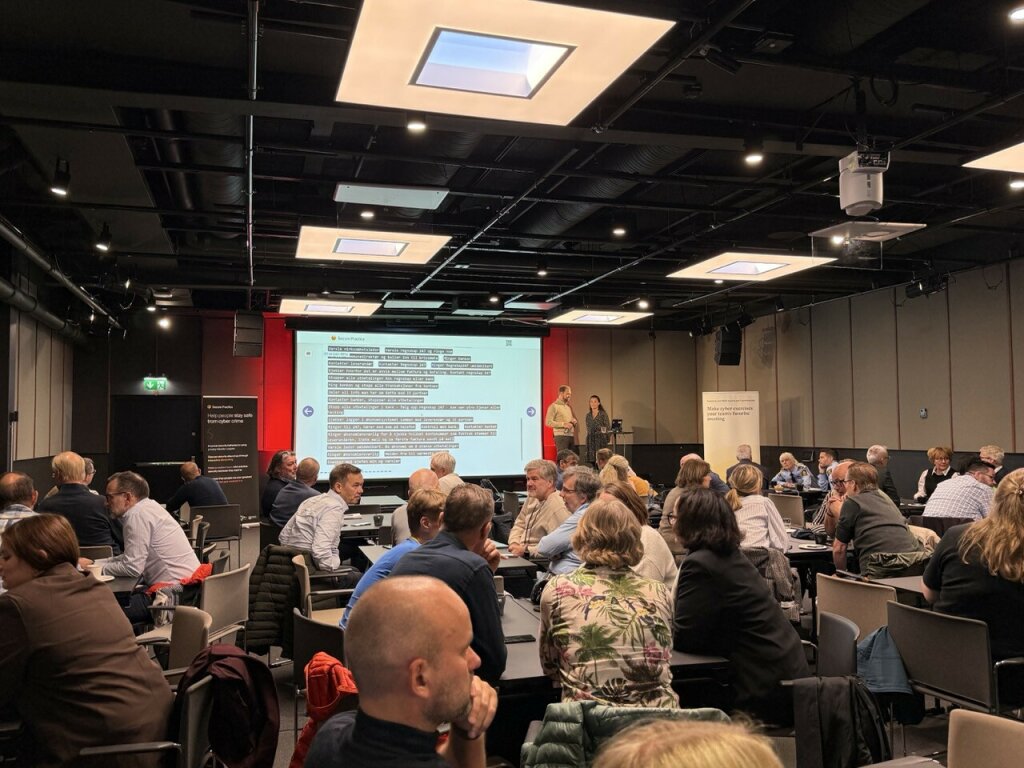 A room full of people taking part in a cybersecurity training exercise.